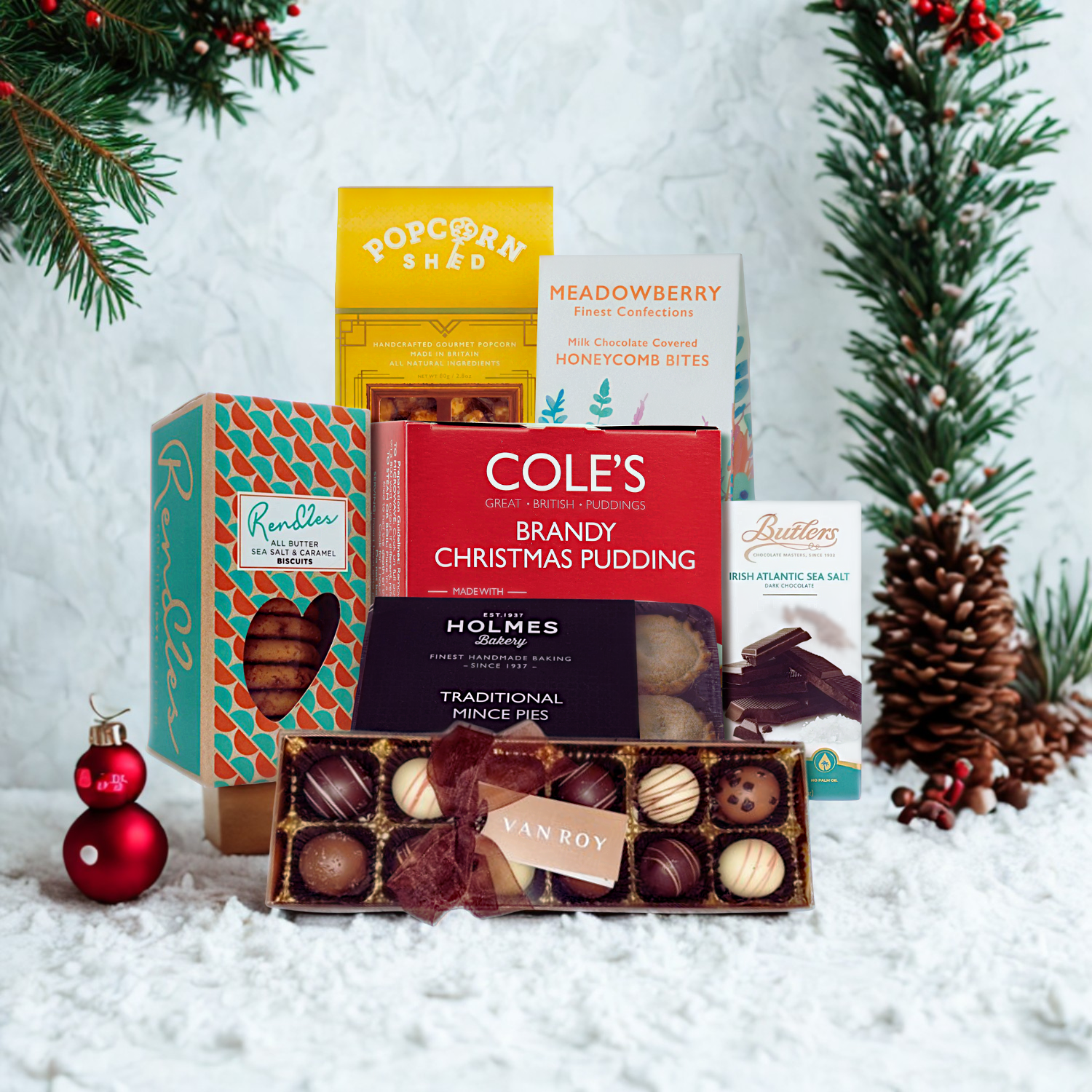 Collection of Christmas-themed products including puddings and mince pies on a snowy background with festive decorations.