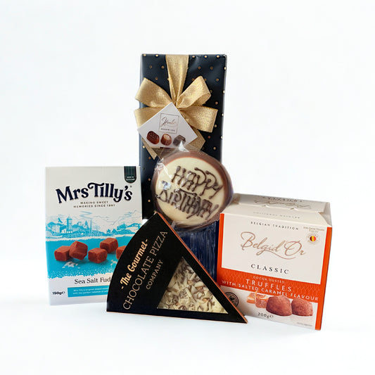 Collection of chocolate products including a box of Mrs Tilly's chocolates, a truffle, and a box of Belaid Or truffles on a white background.