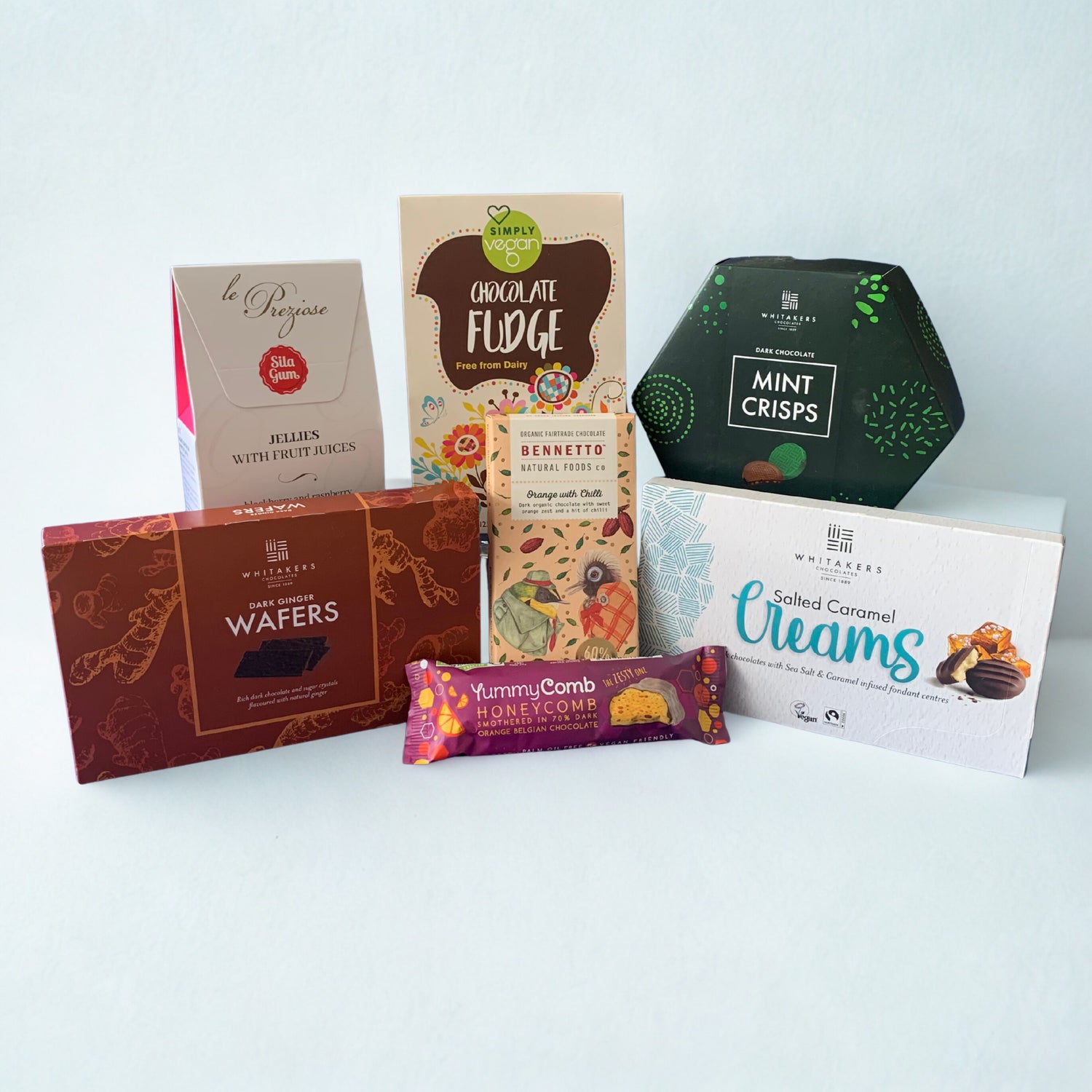 Assorted chocolate bars and packaging on a light blue background