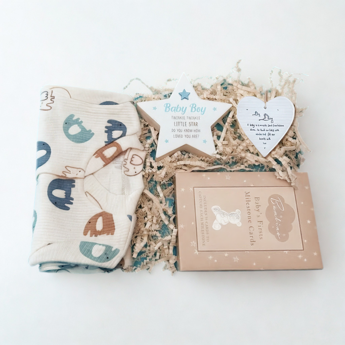 Baby boy gift set with blanket, cards, and decorative items on a white background