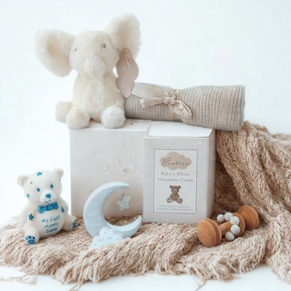 Baby gift set with plush elephant, teddy bear, and baby rattle on a white background